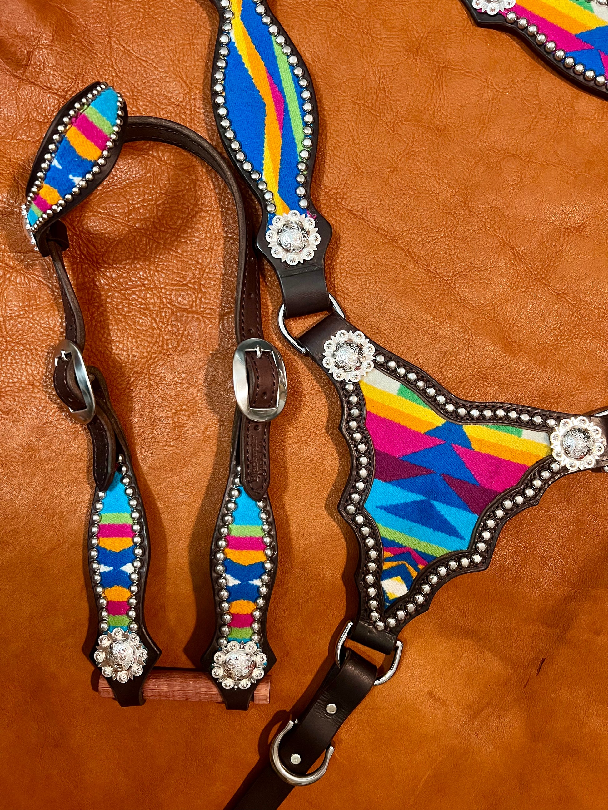 a breast collar and headstall with wool inlay, bright silver spots, and bright silver scalloped berry style conchos