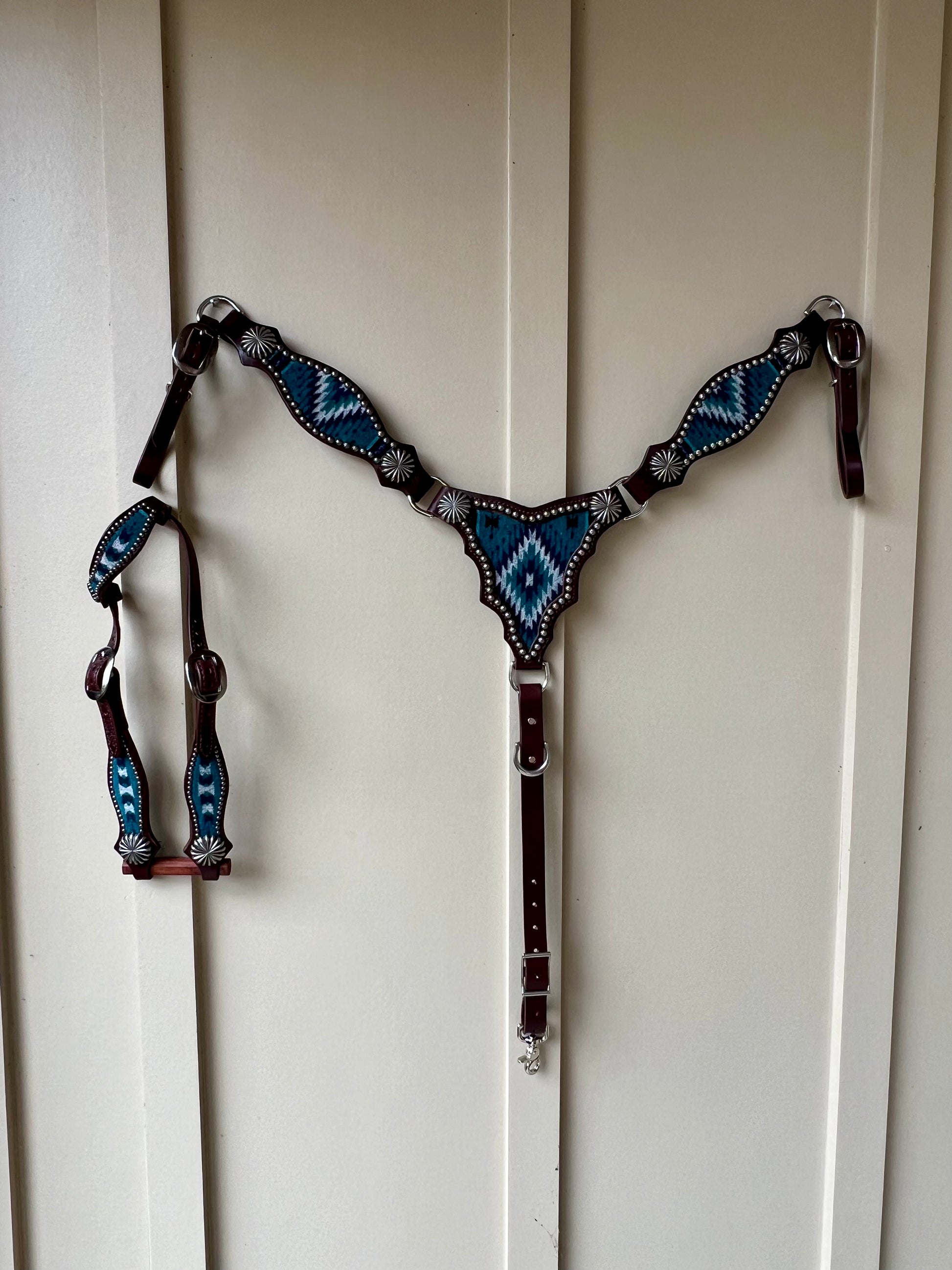 a breast collar and headstall with wool inlay, nickel plated spots, and nickel parachute style conchos