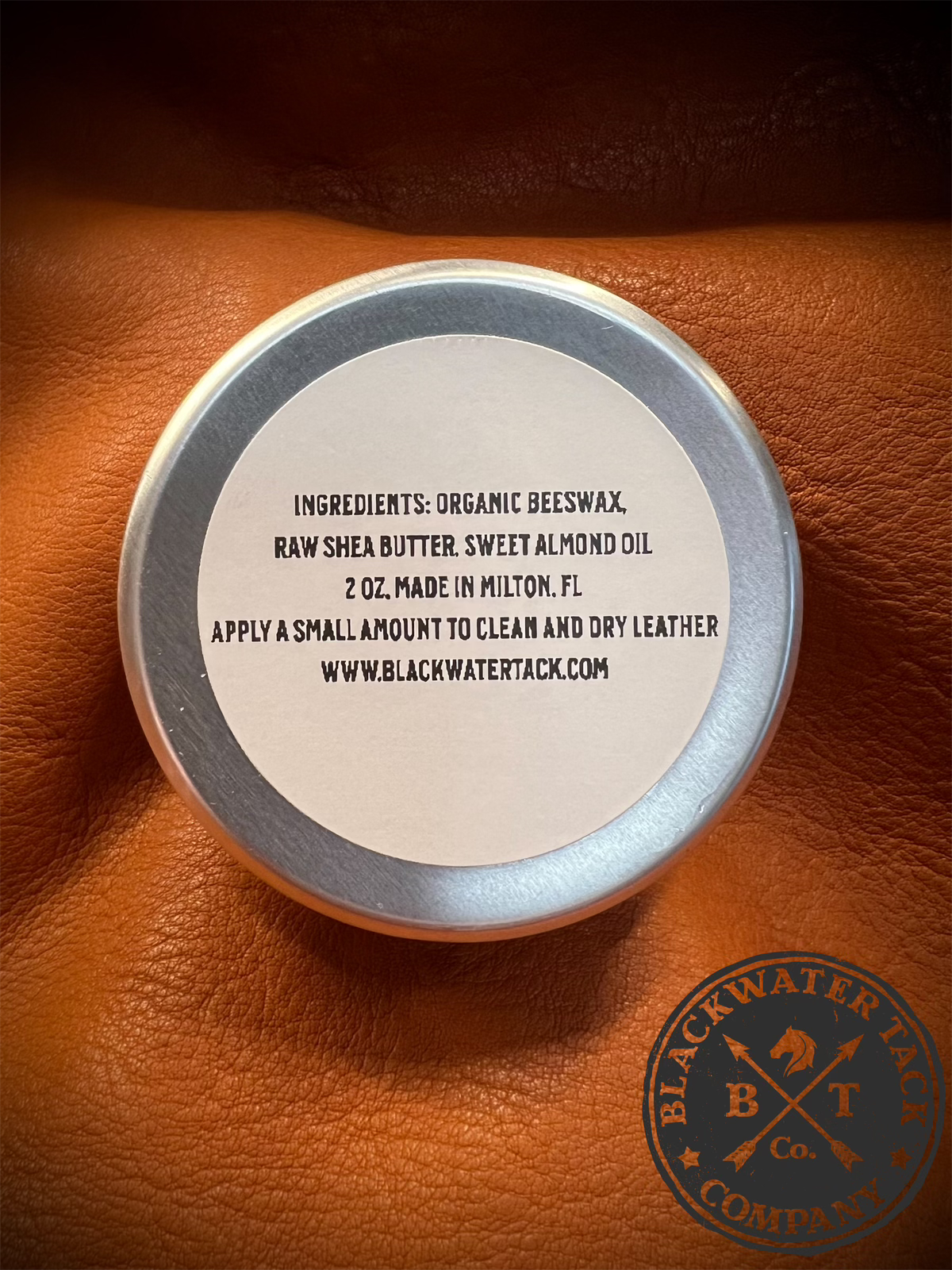 a closed tin of leather balm featuring the ingredients label