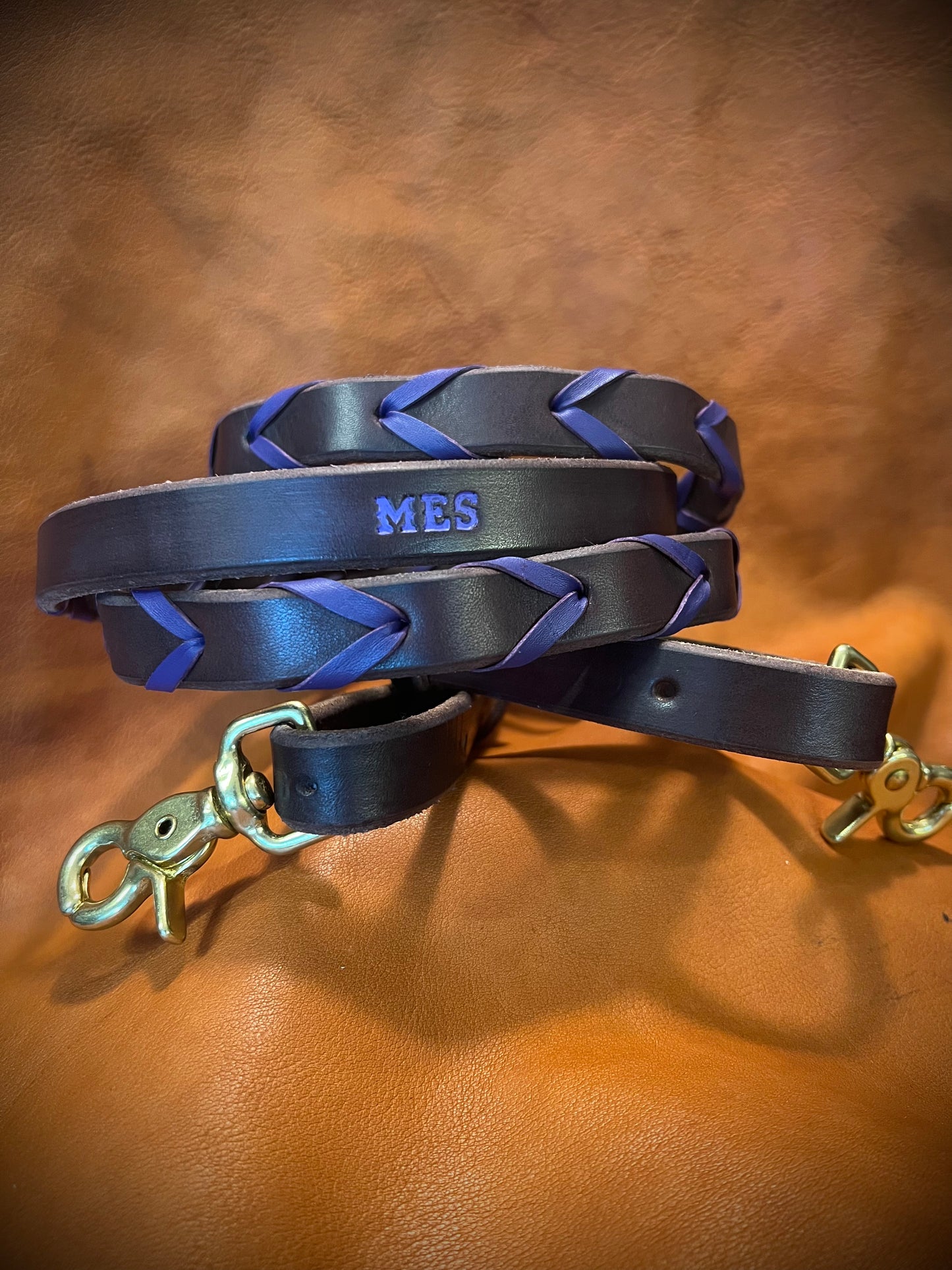 a set of purple laced reins showing the initials M E S