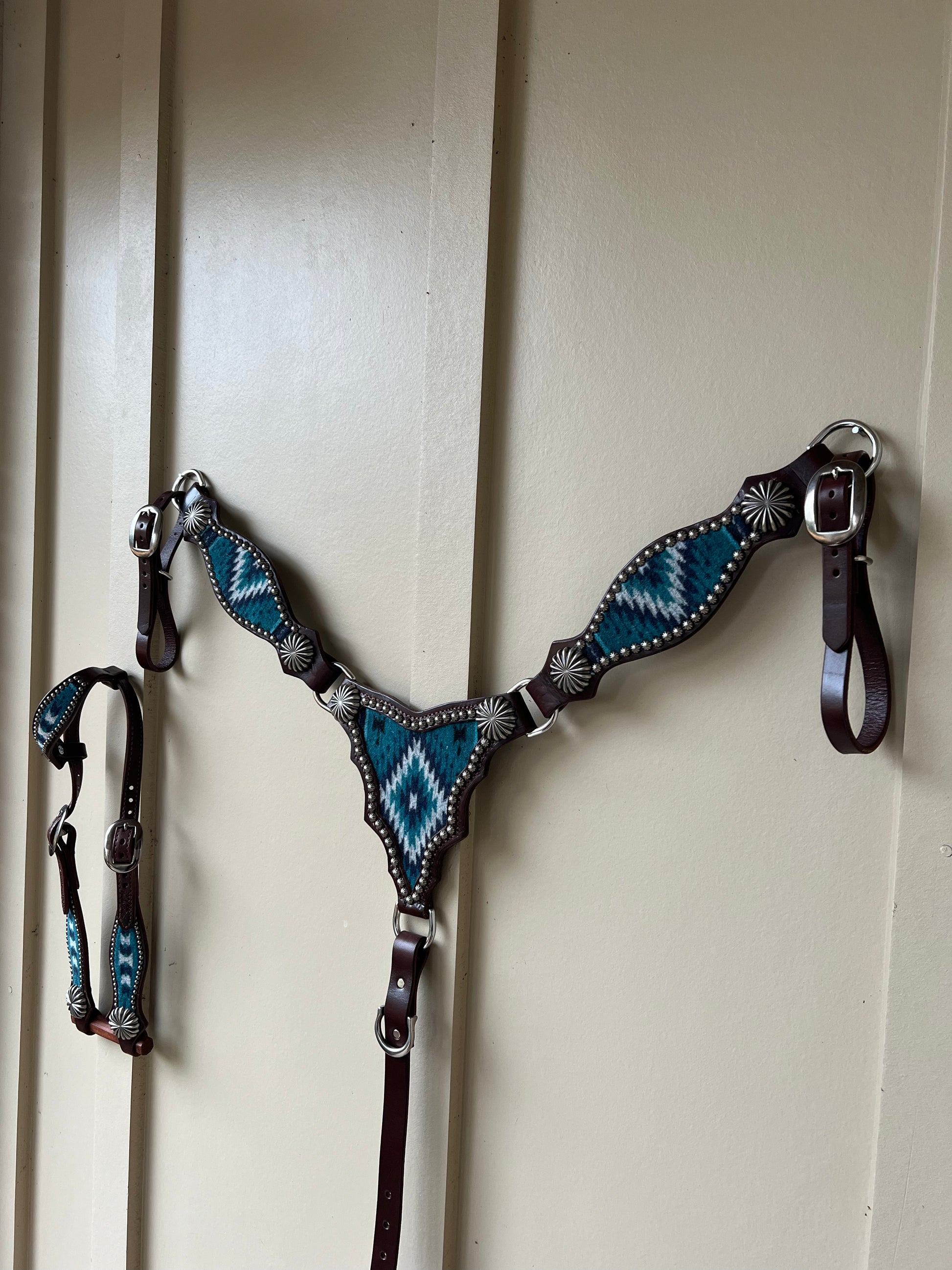 a breast collar and headstall with wool inlay, nickel plated spots, and nickel parachute style conchos