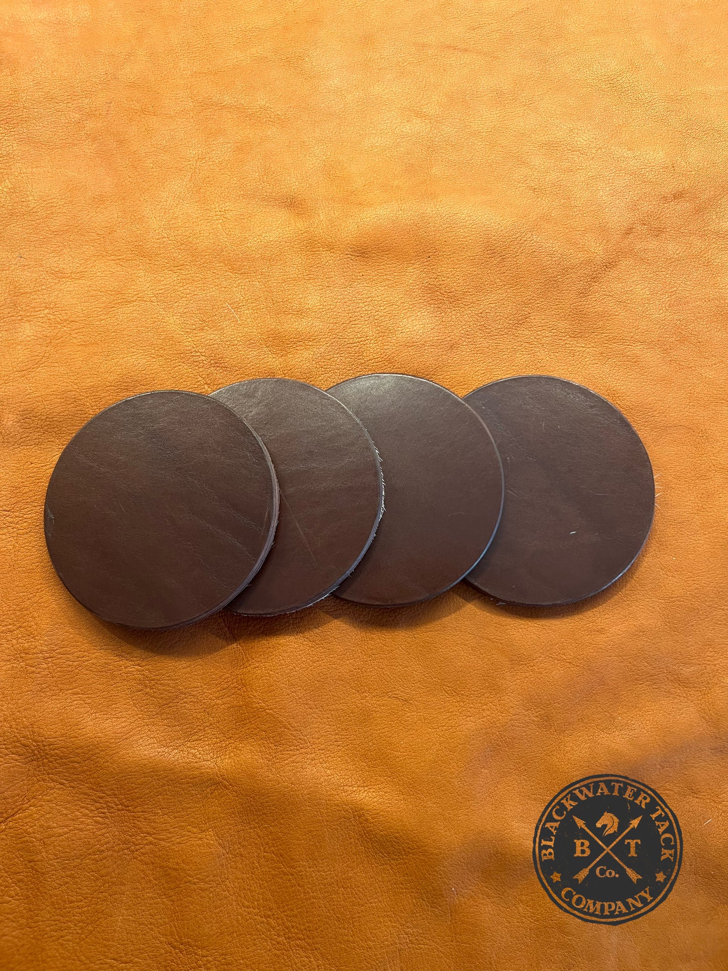 the back of our hair-on-hide coasters featuring brown leather