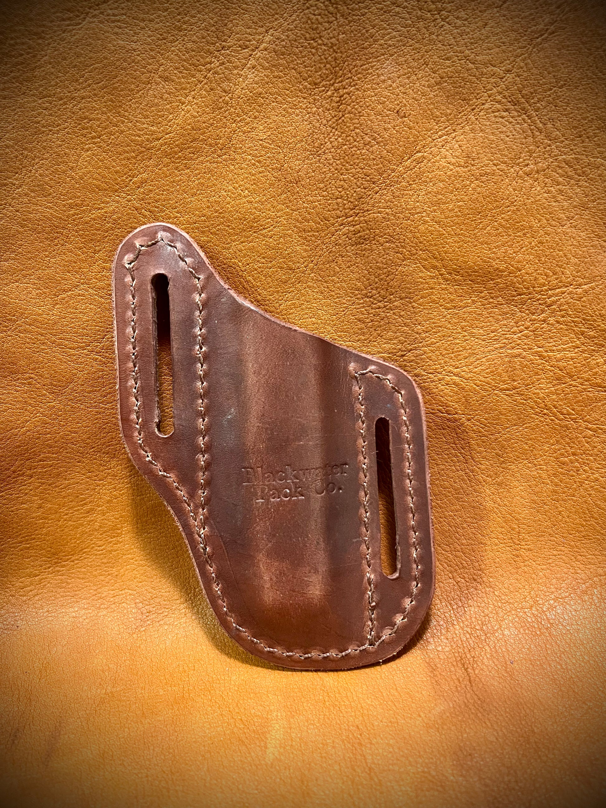 The back of a trapper style knife sheath.