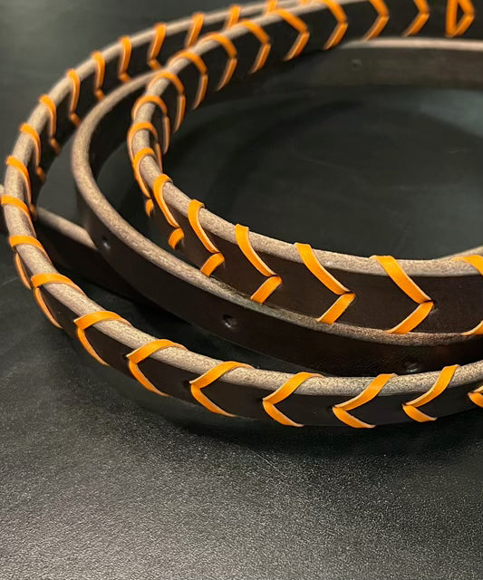 a set of orange laced reins