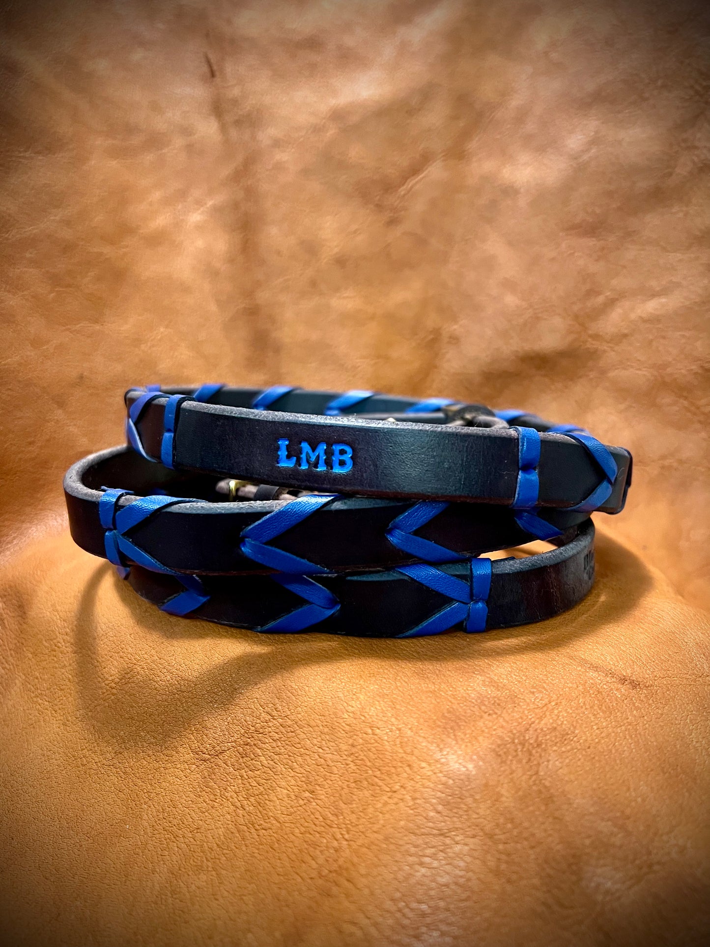 a set of cobalt laced reins with the initials L M B