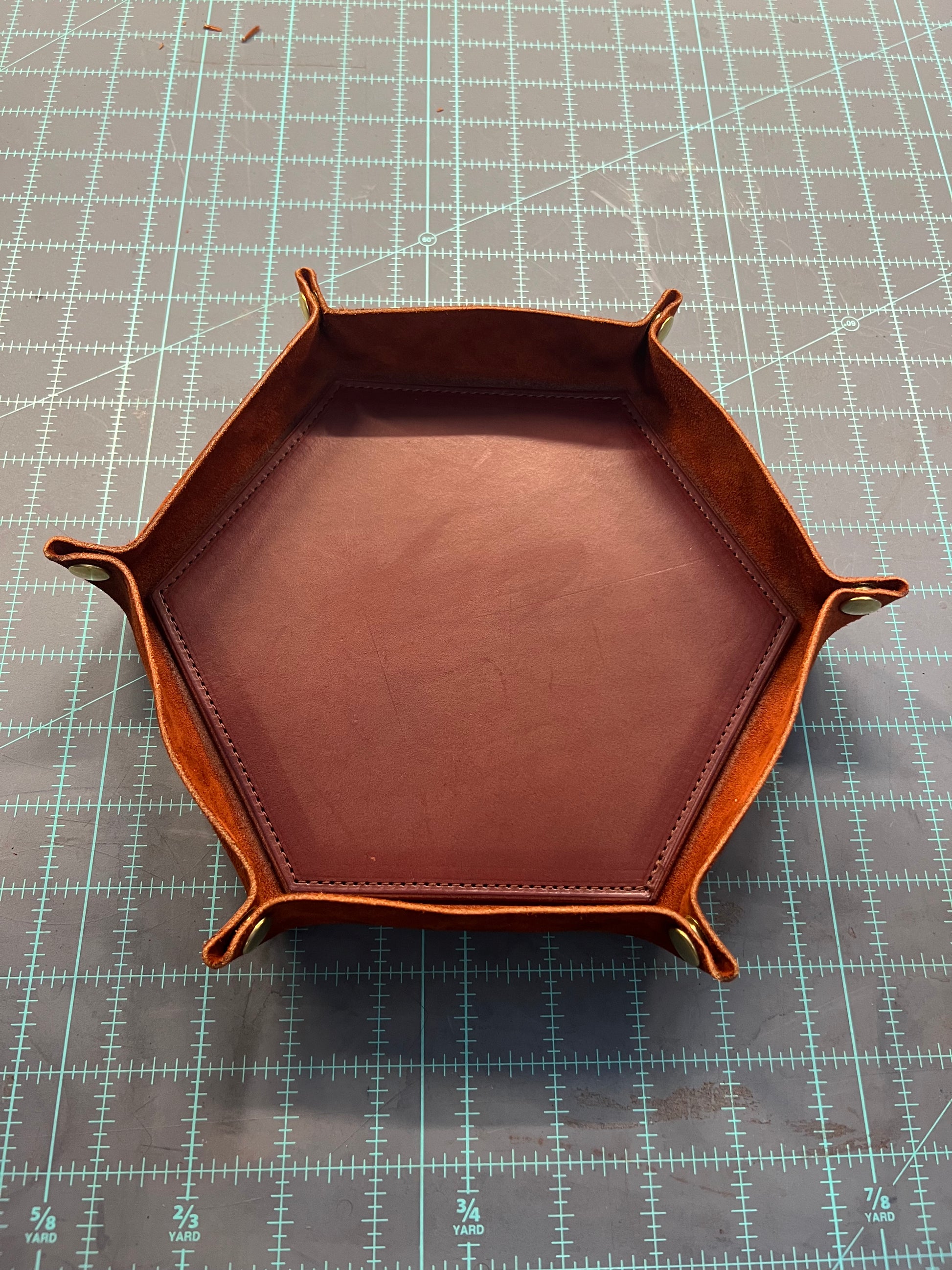 a mahogany colored valet tray with the sides buttoned