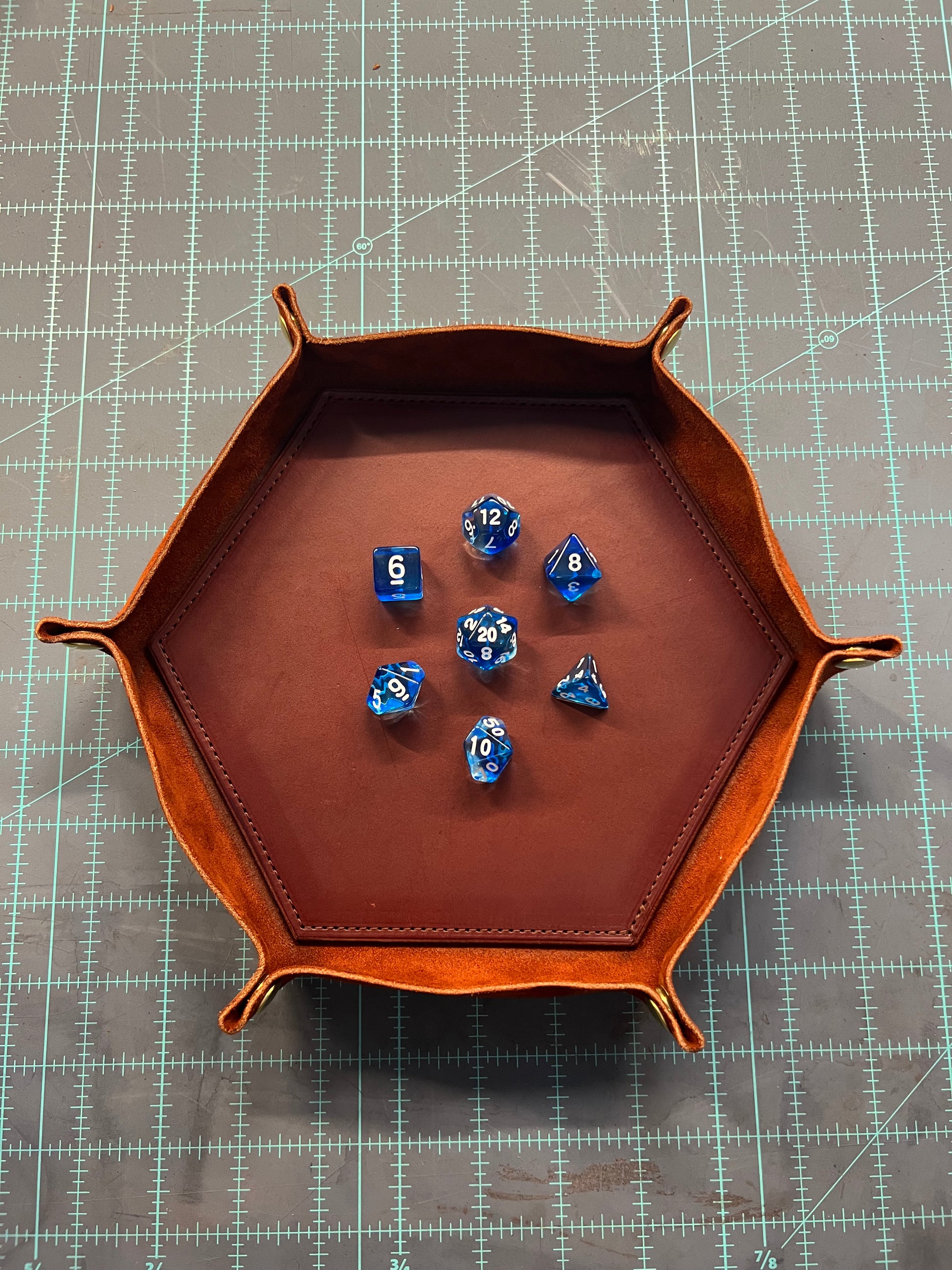 a mahogany colored valet tray with dice inside